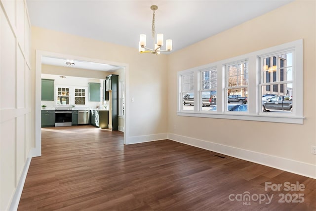 unfurnished dining area featuring visible vents, baseboards, a chandelier, and dark wood-type flooring