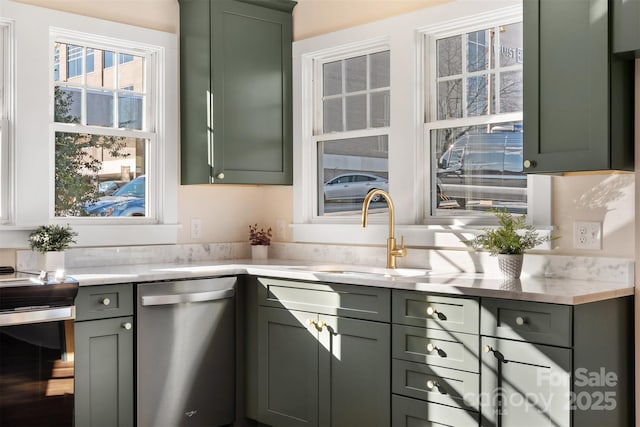 kitchen featuring a sink, light stone countertops, green cabinets, and dishwasher