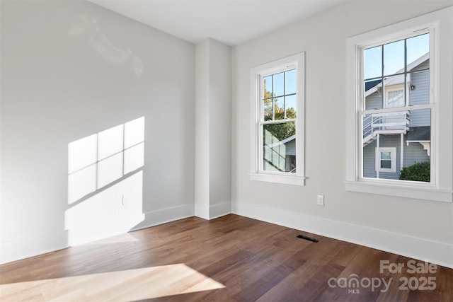 unfurnished room with wood-type flooring