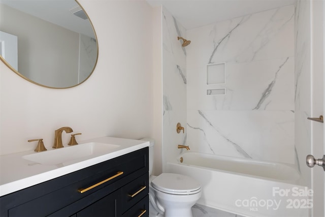 bathroom featuring toilet, marble finish floor, shower / tub combination, and vanity