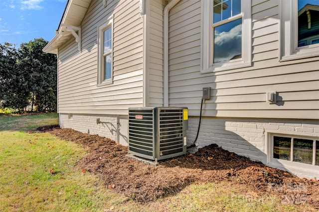 view of home's exterior with a yard and cooling unit