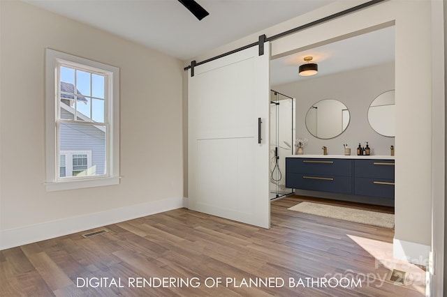 full bathroom with baseboards, visible vents, wood finished floors, walk in shower, and vanity