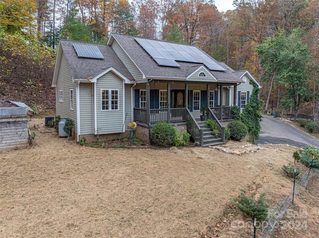 view of front facade with solar panels and a porch