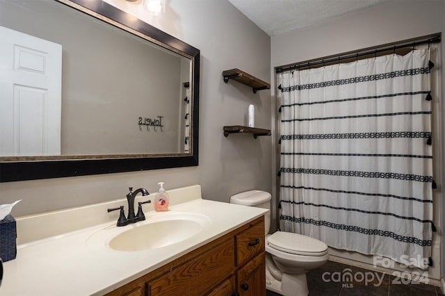 bathroom with a textured ceiling, curtained shower, vanity, tile patterned floors, and toilet