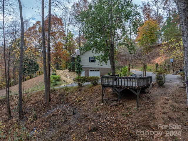 view of yard featuring a garage and a deck