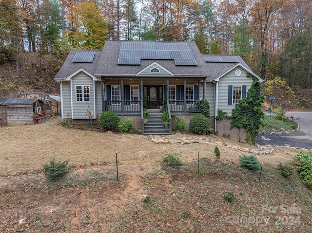 view of front facade featuring solar panels and covered porch