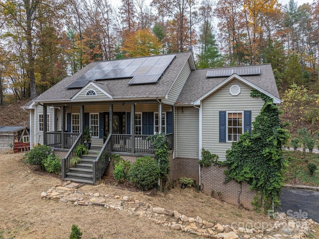 view of front of house featuring solar panels and covered porch