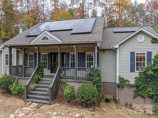 view of front of house featuring solar panels and covered porch