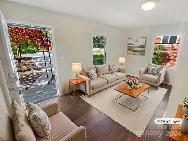 living area featuring baseboards and wood finished floors