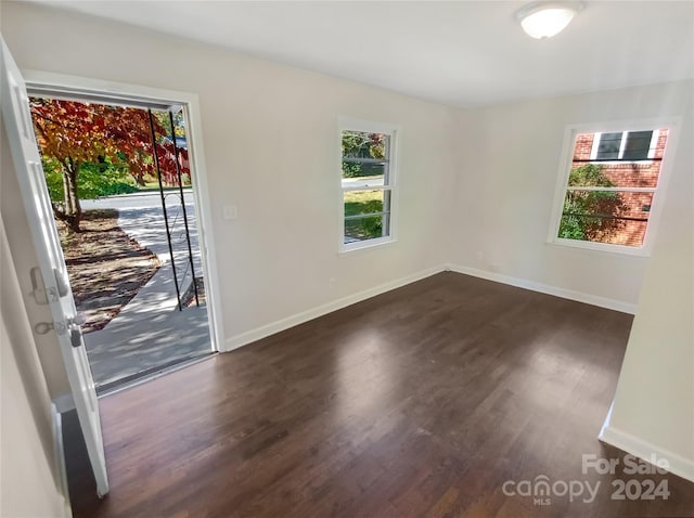 unfurnished room featuring dark hardwood / wood-style floors