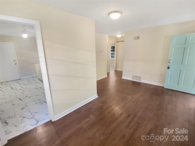 empty room featuring dark hardwood / wood-style flooring