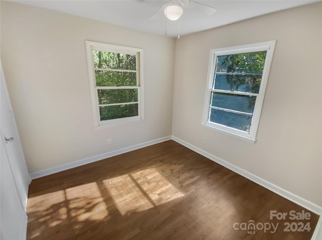 empty room featuring dark hardwood / wood-style floors and ceiling fan