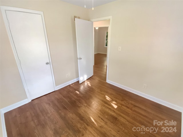 unfurnished bedroom with hardwood / wood-style floors