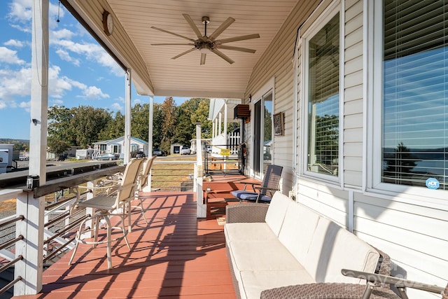 wooden deck featuring ceiling fan