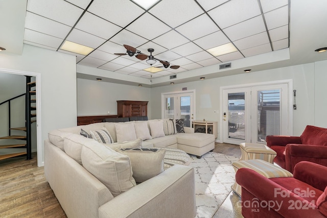 living room with french doors, wood-type flooring, and ceiling fan