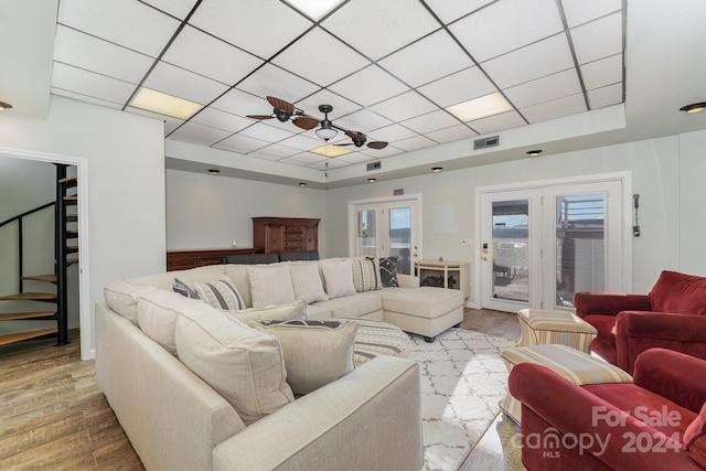 127 Lake View Dr, New London, NC 28127 - living area featuring stairs, a paneled ceiling, a tray ceiling, and wood finished floors