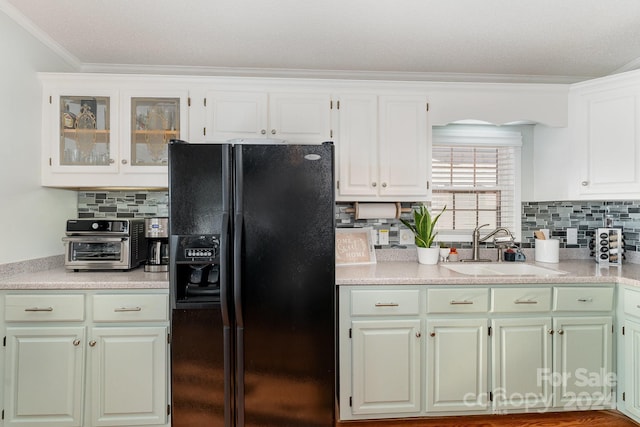 127 Lake View Dr, New London, NC 28127 - kitchen with black refrigerator with ice dispenser, a sink, ornamental molding, light countertops, and decorative backsplash