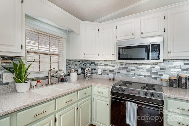 kitchen featuring sink, black electric range, crown molding, lofted ceiling, and white cabinets