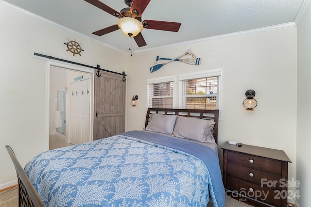 carpeted bedroom featuring a closet, a barn door, ceiling fan, and crown molding