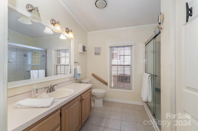 bathroom with vanity, crown molding, a shower with shower door, tile patterned floors, and toilet