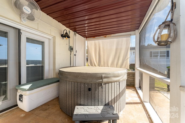 sunroom with a hot tub, a wealth of natural light, and wood ceiling