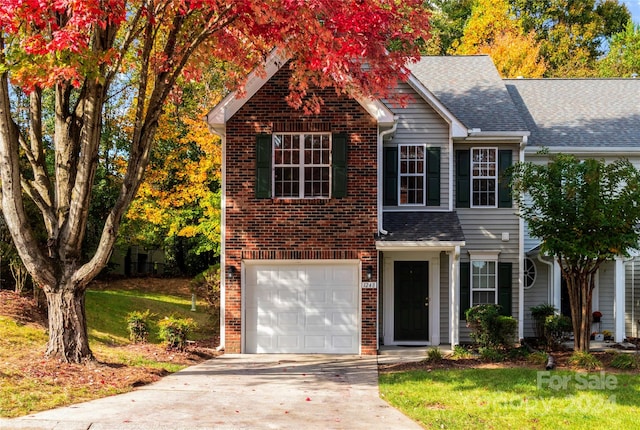 view of front facade featuring a front lawn and a garage