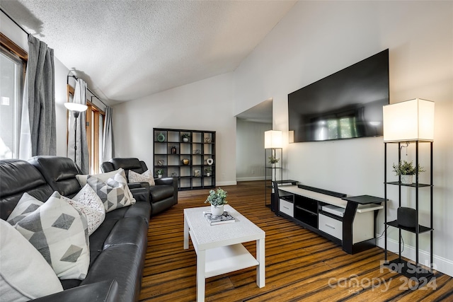 living room with a textured ceiling, vaulted ceiling, and dark wood-type flooring