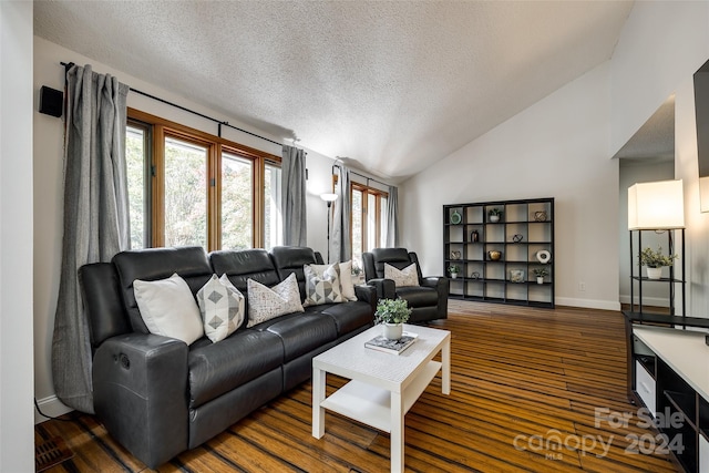 living room with vaulted ceiling, a textured ceiling, and dark hardwood / wood-style floors