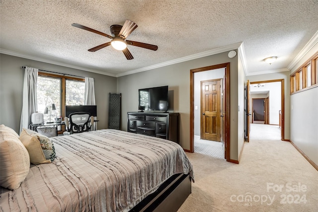 bedroom with a textured ceiling, ceiling fan, crown molding, and light carpet