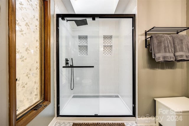 bathroom featuring toilet and an enclosed shower