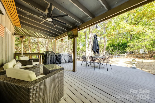 wooden deck with ceiling fan and area for grilling