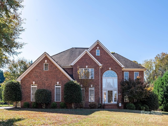 front of property featuring french doors and a front lawn