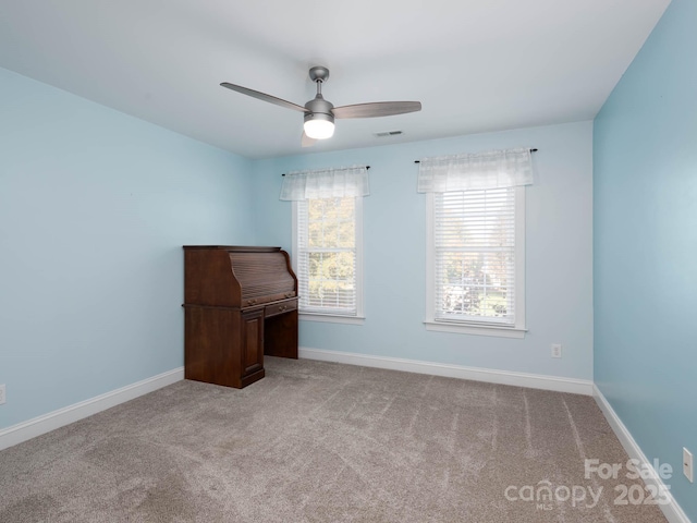 empty room featuring light carpet and ceiling fan