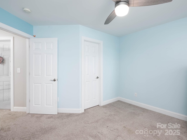 unfurnished bedroom with light colored carpet and ceiling fan