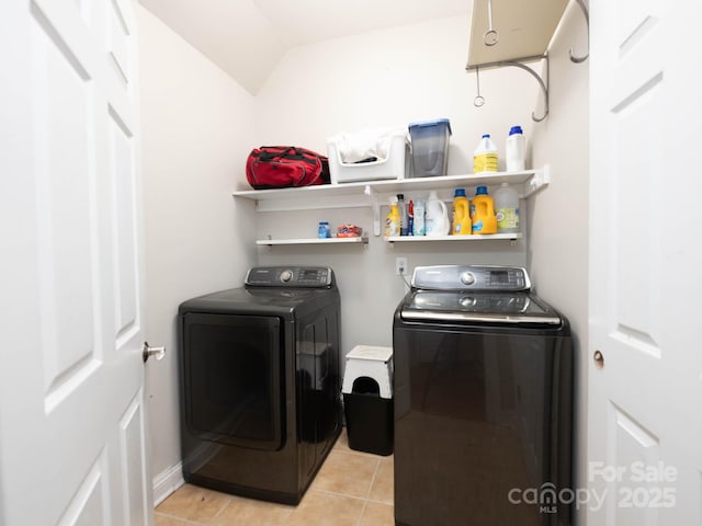 laundry room with washing machine and dryer and light tile patterned flooring