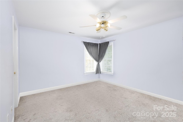 spare room with carpet floors and ceiling fan