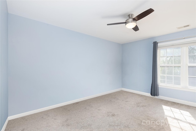 empty room with ceiling fan and carpet flooring