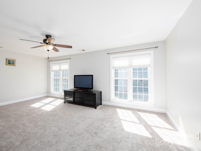 unfurnished living room with light colored carpet and ceiling fan