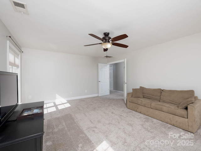 unfurnished living room with light colored carpet and ceiling fan