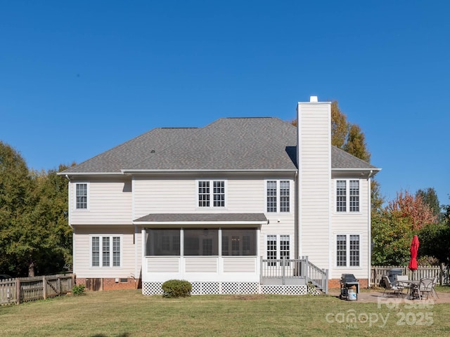 back of property with a yard, a sunroom, a patio, and a deck