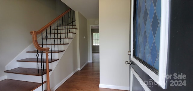 stairs featuring hardwood / wood-style flooring