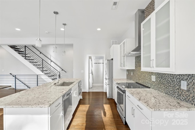 kitchen with hanging light fixtures, white cabinetry, sink, and appliances with stainless steel finishes