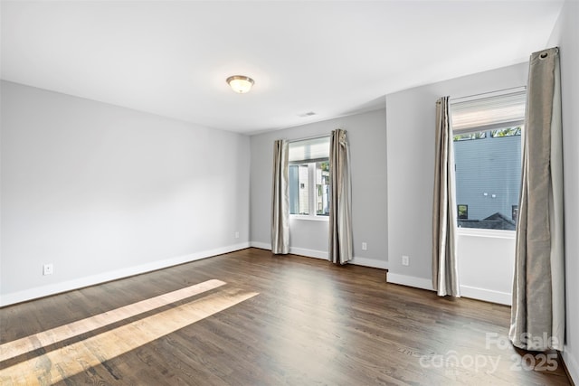 spare room featuring dark wood-type flooring