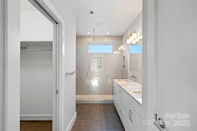 bathroom featuring vanity and an enclosed shower