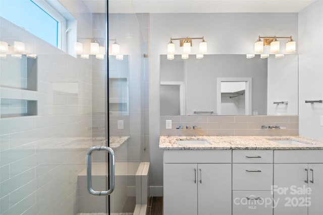 bathroom featuring vanity, backsplash, and walk in shower