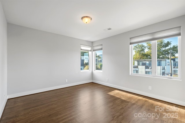 unfurnished room featuring dark hardwood / wood-style floors