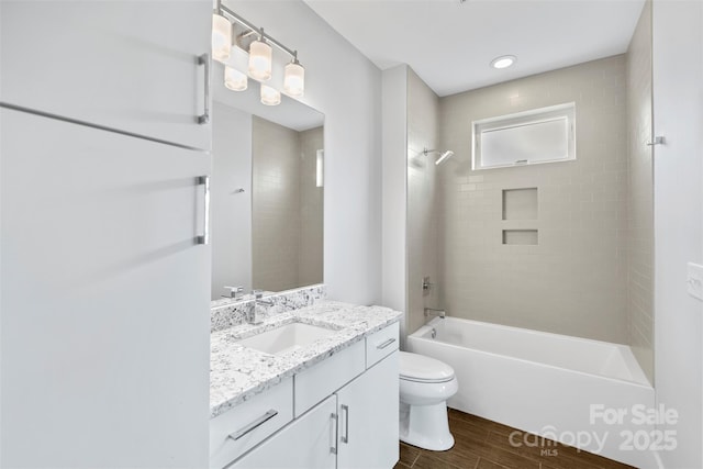 full bathroom with vanity, toilet, and tiled shower / bath