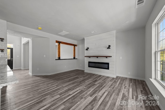 unfurnished living room featuring light wood-type flooring and a fireplace