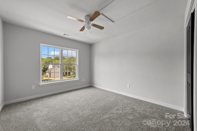 spare room with ceiling fan and carpet