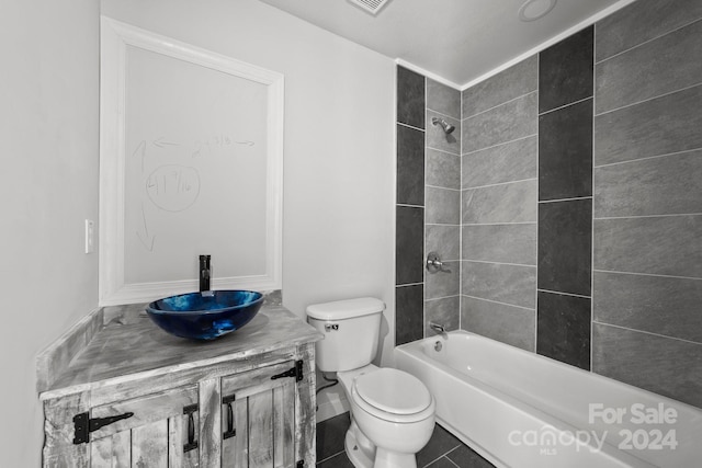 full bathroom with tile patterned flooring, vanity, toilet, and tiled shower / bath combo